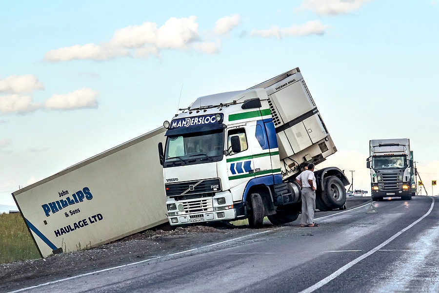 jackknife truck on the side of the road shows example of one of the most common types of truck accidents