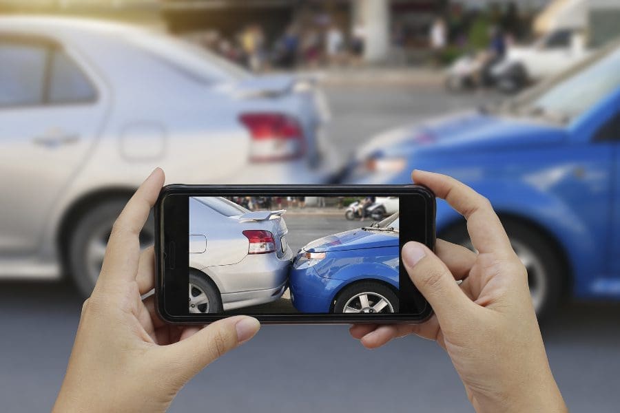 A Person taking a Photo of a Car Accident with Mobile