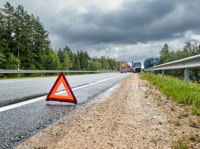 caution sign in the road warns drivers to avoid a truck accident scene in case of danger