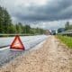 caution sign in the road warns drivers to avoid a truck accident scene in case of danger