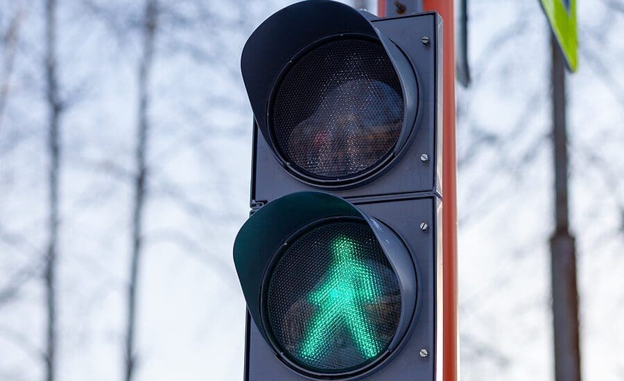 Green light on a pedestrian traffic light. Safe crossing of the road by pedestrians.