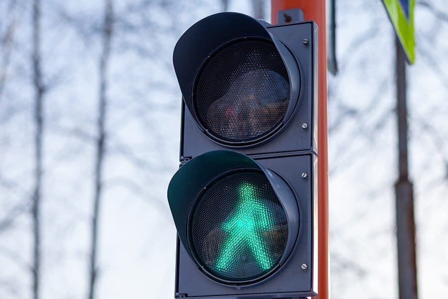Green light on a pedestrian traffic light. Safe crossing of the road by pedestrians.