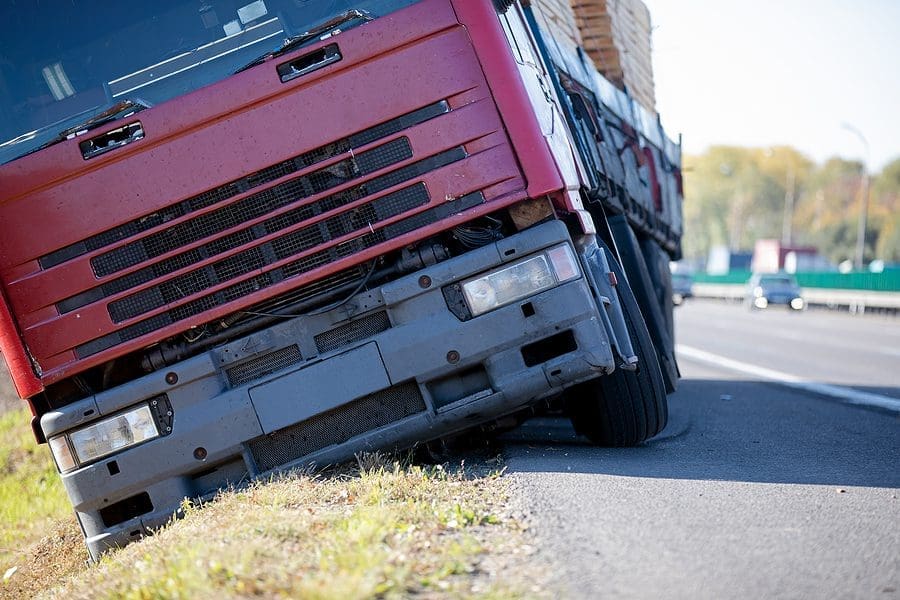 Truck accident. Lorry trailer car lost control, left interstate road and plunges into ditch