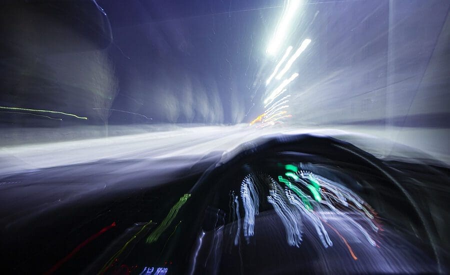 blur motion inside car light trail represent moving car or drunk driver