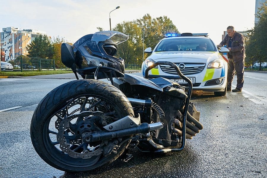 damaged motorbike on the city road at the scene of an accident