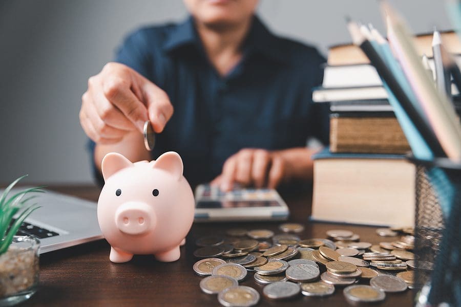 A Man putting money in the saving bank