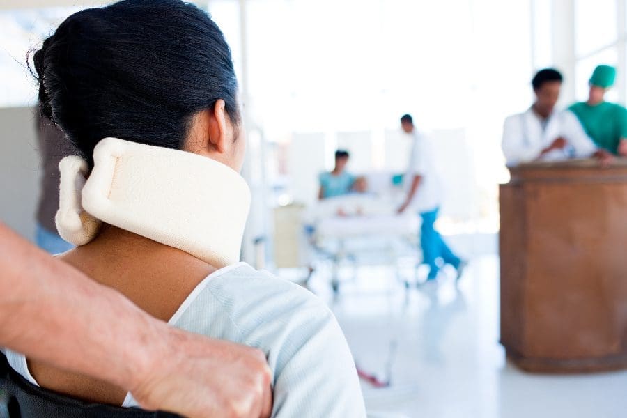 A Doctor taking a patient on a wheelchair to the front desk