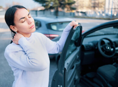 Woman holding her neck in pain after a minor car accident