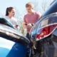 Two motorists exchanging information after a car accident with no injuries