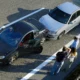 Group of people at the scene of a minor fender bender discussing if they should report it