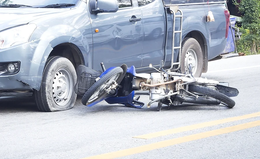 aftermath of a motorcycle accident involving a collision between a truck and a motorcyclist