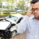 man making a call to his insurance company after a car accident