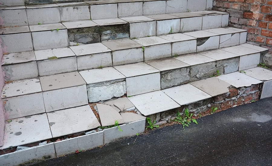 unsafe stairs with broken tiles and uneven steps