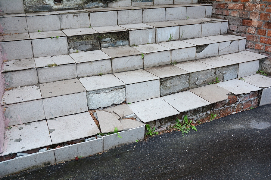 unsafe stairs with broken tiles and uneven steps