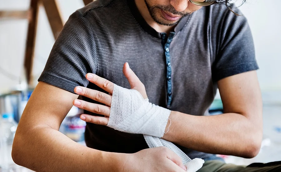 young man wraps injured wrist after an edgemoor personal injury accident where he fell off a ladder