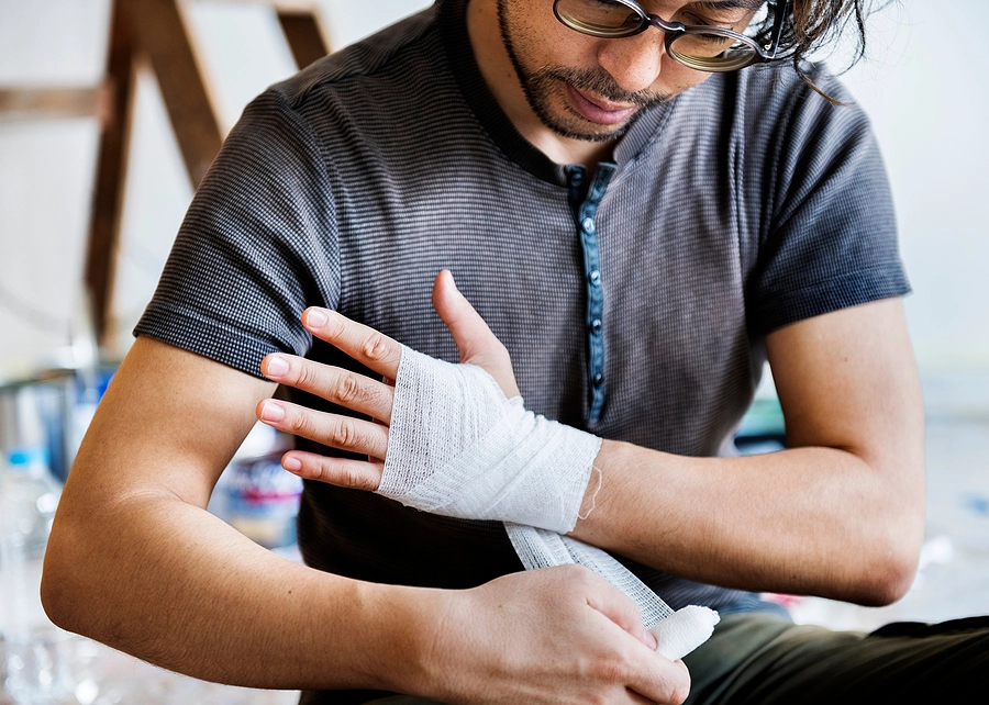 young man wraps injured wrist after an edgemoor personal injury accident where he fell off a ladder