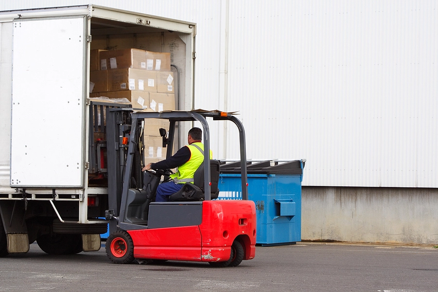 forklift operator loading cargo into a gulfport truck for transportation