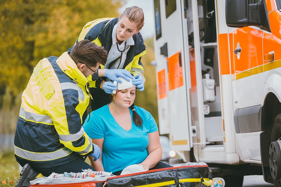 woman with a head injury being loaded into an ambulance after a kenneth city truck accident