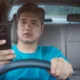 asian male driver texting while driving represents an example of negligence in an automobile accident